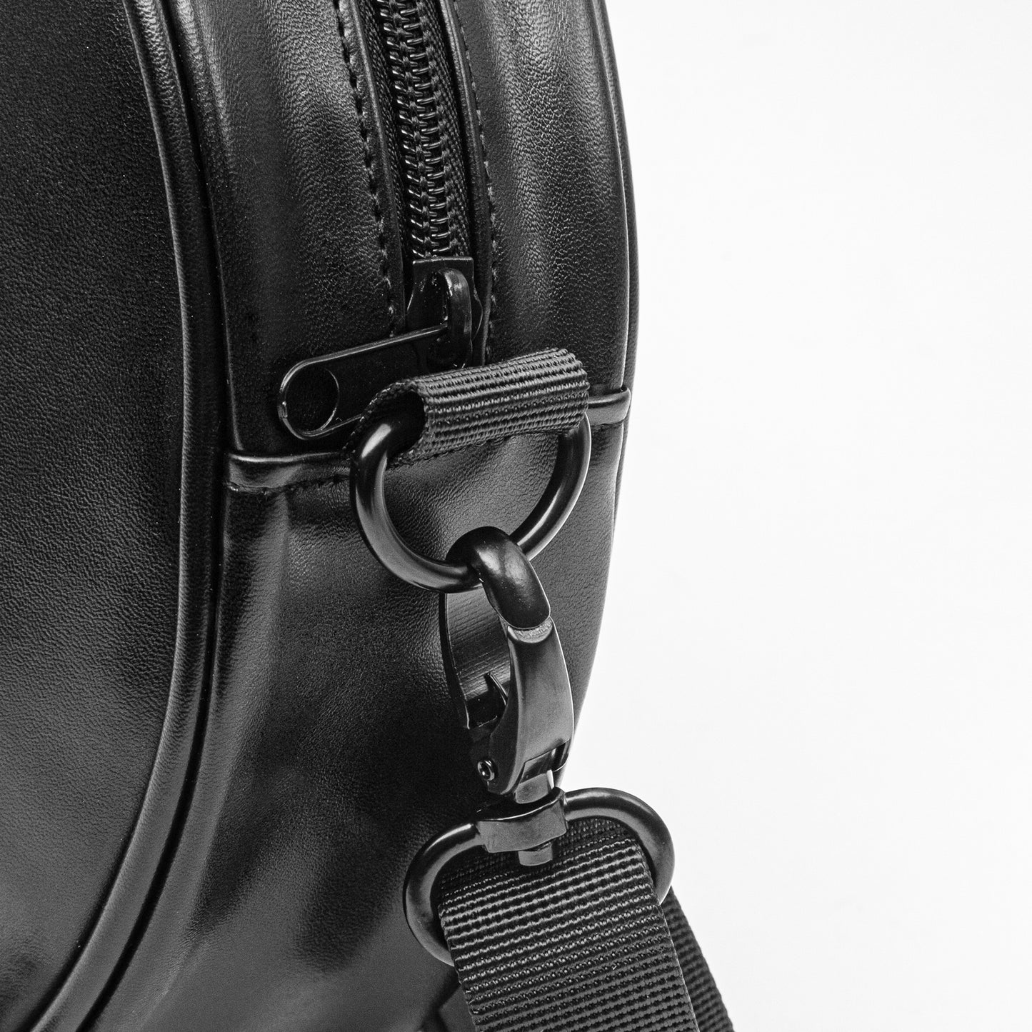 Close-up of a bright and  black africa leather bag with a zipper and strap 