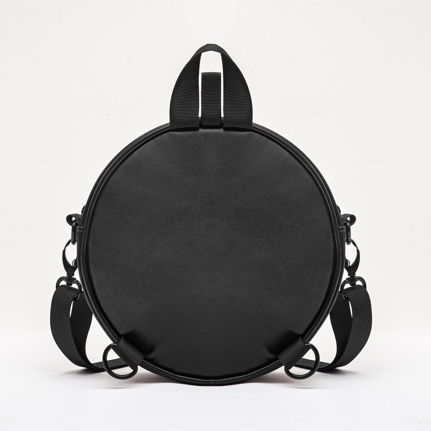 Black round bag with shoulder straps on 