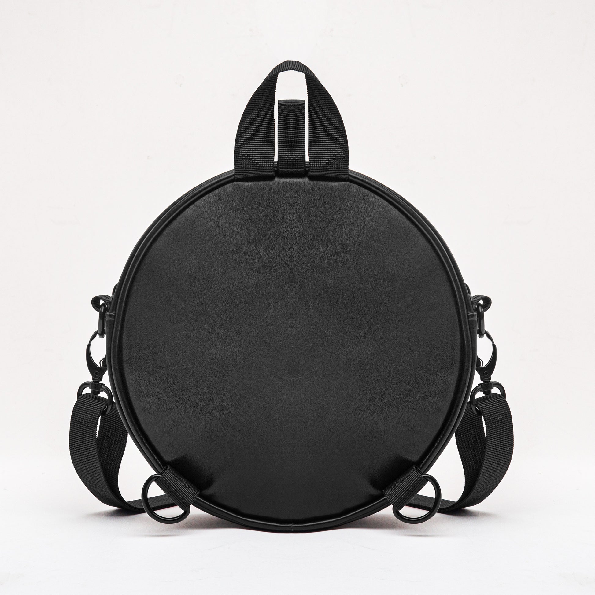 Black round bag with shoulder straps on 